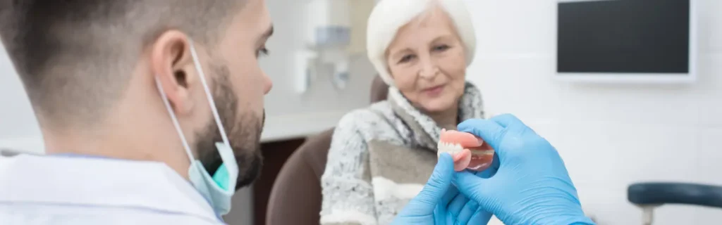 Dentist explaining removable dentures to a senior patient